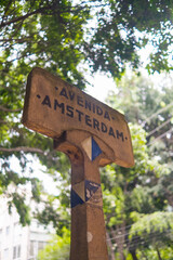 Amsterdam avenue sign with blurry tree as background
