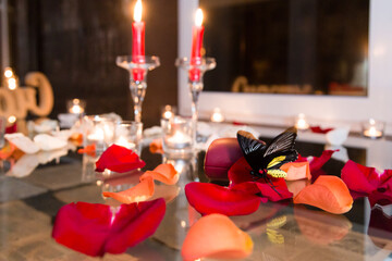 Gold ring, wedding ring in red box and, red heart on white-red background with beautiful bokeh. The moment of a wedding, anniversary, engagement, or Valentine's Day. Happy day.