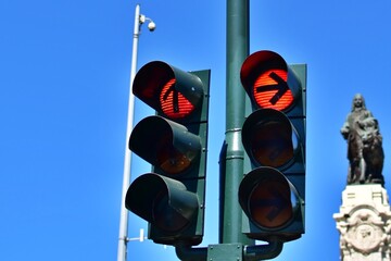 Traffic light on the street. Red traffic signal in all directions on blurred cityscape background