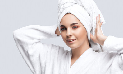 Portrait of a beautiful brunette girl in a white coat, with healthy clean skin and fresh make-up....