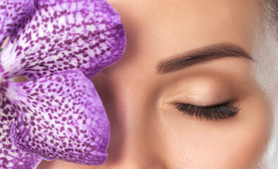 Beautiful woman with long eyelashes, beautiful make-up and thick eyebrows. Professional makeup and...