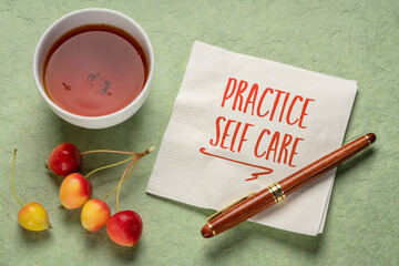 practice self care - inspirational reminder, handwriting on a napkin with a cup of tea, lifestyle and health concept