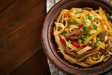 tsuivan traditional mongolian dish with meat vegetables homemade pasta wooden background top view copy space flat lay
