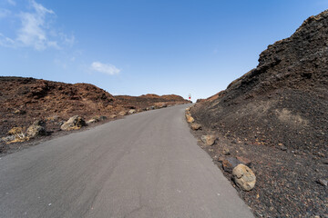 Rocky coast of the Atlantic Ocean at Cape Teno. A lighthouse in the background. Tenerife. Canary Islands. Spain.