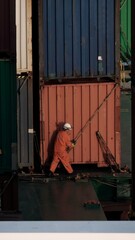 Obraz premium A seaman making lashing on a container ship