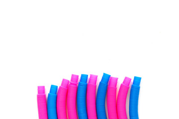 pop tube trending toy of 2021. anti-stress sensory plastic toy from a tube of pink and blue color on an isolated white background. Flat lay with place for text.