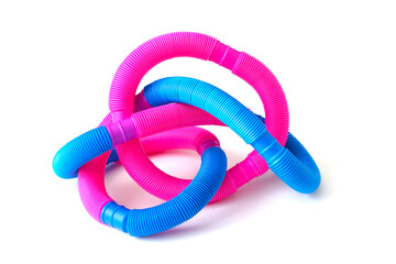 pop tube trending toy of 2021. anti-stress sensory plastic toy from a tube of pink and blue color on an isolated white background. Corrugated metamarphosis. Flat lay with place for text.