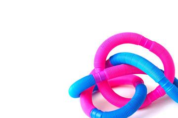 pop tube trending toy of 2021. anti-stress sensory plastic toy from a tube of pink and blue color on an isolated white background. Corrugated metamarphosis. Flat lay with place for text.
