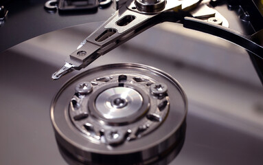 A macro shot of an open hard disk drive.