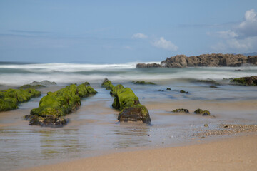 Rocks covered by seaweeds in As Furnas beach