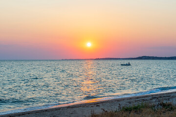 Gorgeous view on sunset on sea on summer day. Sea and sky converging on horizon. Greece.