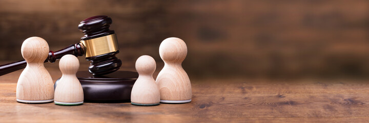 Separation Of Pawn Wooden Figure In From Of Gavel