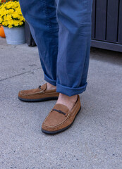 Man in blue pants wearing a pair of traditional leather suede fabric bit drivers for a mens footwear lifestyle.