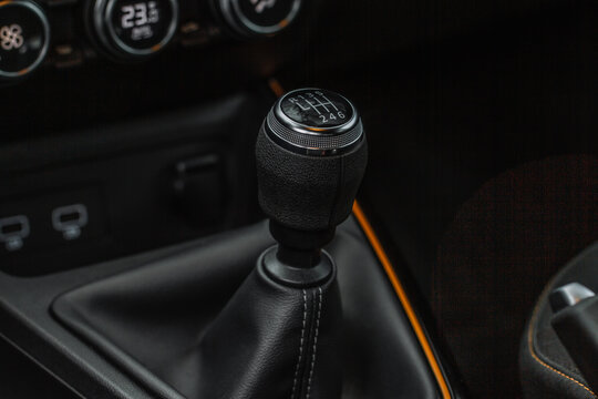 Manual transmission shift selector in the car interior. Gear shift handle in a modern car. Gear box transmission stick shift lever.