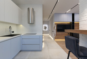 Modern luxury stylish apartment interior in pastel colors. a very bright room with huge windows filled with daylight. blue walls, wooden parquet floors