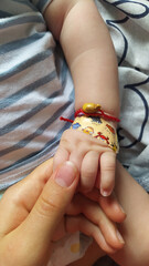 Closeup shot of an adult holding a baby's hand