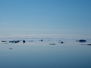 photos of mountains, glaciers, icebergs, and sea ice in the Canadian Arctic landscape. 