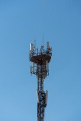 Telecommunication mobile communication antenna on blue sky background