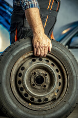 Repairman's male hands with a wrench. Vehicle fitter inspecting used car engine