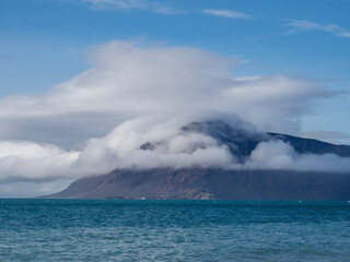 Naklejka premium photo of mountain, glacier, sea ice, ocean and icebergs in the canadian arctic