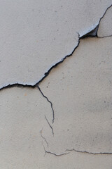 Fototapeta premium Old wall with cracked plaster. Weathered rough surface. Vintage texture is perfect for background and design.