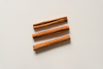 three cinnamon sticks isolated on paper