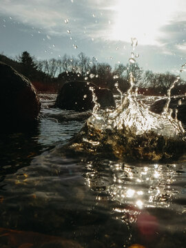 Closeup of water splashing with sunlight shining through
