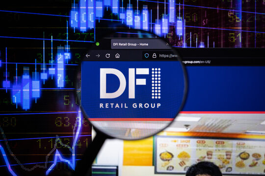DFI Retail Group company logo on a website with blurry stock market developments in the background, seen on a computer screen through a magnifying glass	