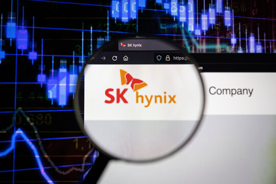 SK Hynix company logo on a website with blurry stock market developments in the background, seen on a computer screen through a magnifying glass	