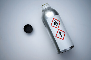 A metal bottle with a toxic substance on a white isolate. Glue for gluing organic glass. Chemical...