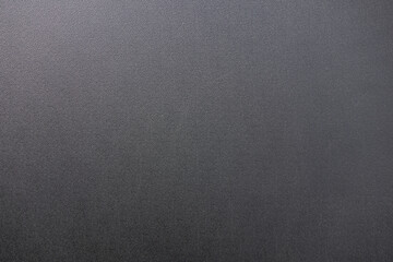 Texture of black matte plastic.Black background for the text. Dark plastic.