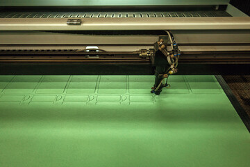 Cutting felt fabric on a laser machine. Cutting out details on fabric using a computer. Work for a...