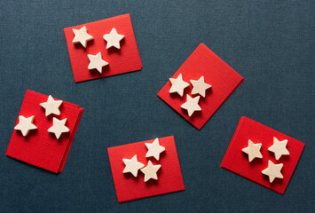 wooden stars on red paper squares