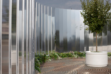 Mirror wall in the park. Architectural element to decorate the city. Reflective surface.