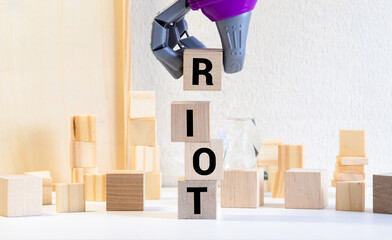 Riot - word from wooden blocks with letters, noisy and violent public gathering concept, random...