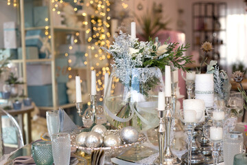 Nicely set table for dinner by the window. Wedding table served in white and blue colors
