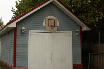 Basketball hoop in the yard of the house. Sports equipment. House for the game.