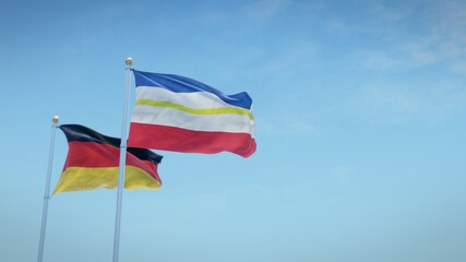 Waving flags of Germany and the German state of Mecklenburg-Vorpommern against blue sky backdrop. 3d rendering