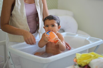 criança ensaboada tomando banho