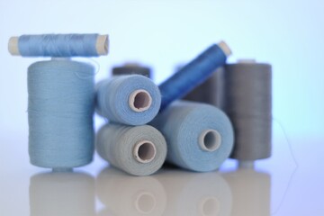 thread spools. Sewing threads set.Blue and gray thread spools .Needlework and sewing.Hobby and...