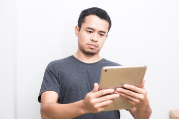 Business asian man use ipad tablet computer standing