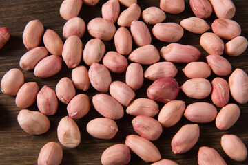 raw peanuts seed on wooden background