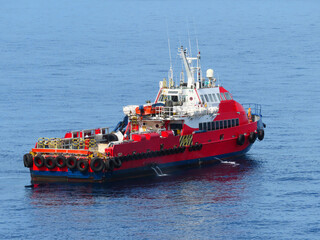 Supply boat transfer the cargo for supporting oil and gas industry and moving cargo from the boat to the platform. Boat is waiting transfer cargo and crews to platform.	