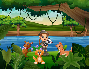 Happy zookeeper girl with animal in the jungle
