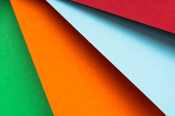 Abstract rainbow background with colored paper. Dark tones.