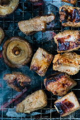 Top view of Mushrooms and meat grilling on a barbecue