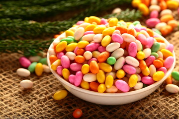 Colorful  cumin seed sweets on a vintage background.