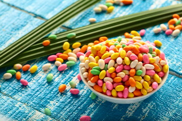 Colorful  cumin seed sweets on a vintage background.