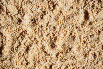 Sand Texture. Brown background from fine sand. Dune in the sun with shadow