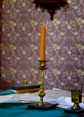 Retro antique desk of a writer, paper, books, candle in a candlestick